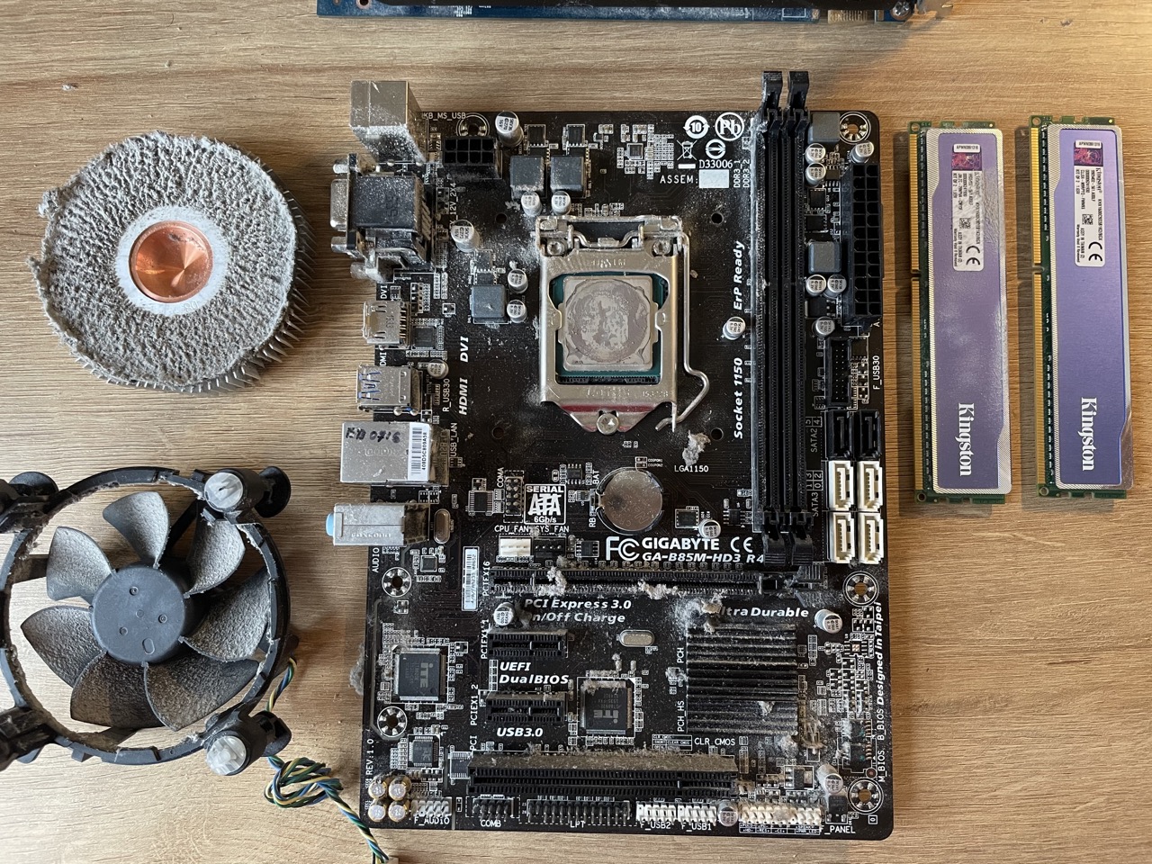 Dusty motherboard and cpu cooler before the cleaning